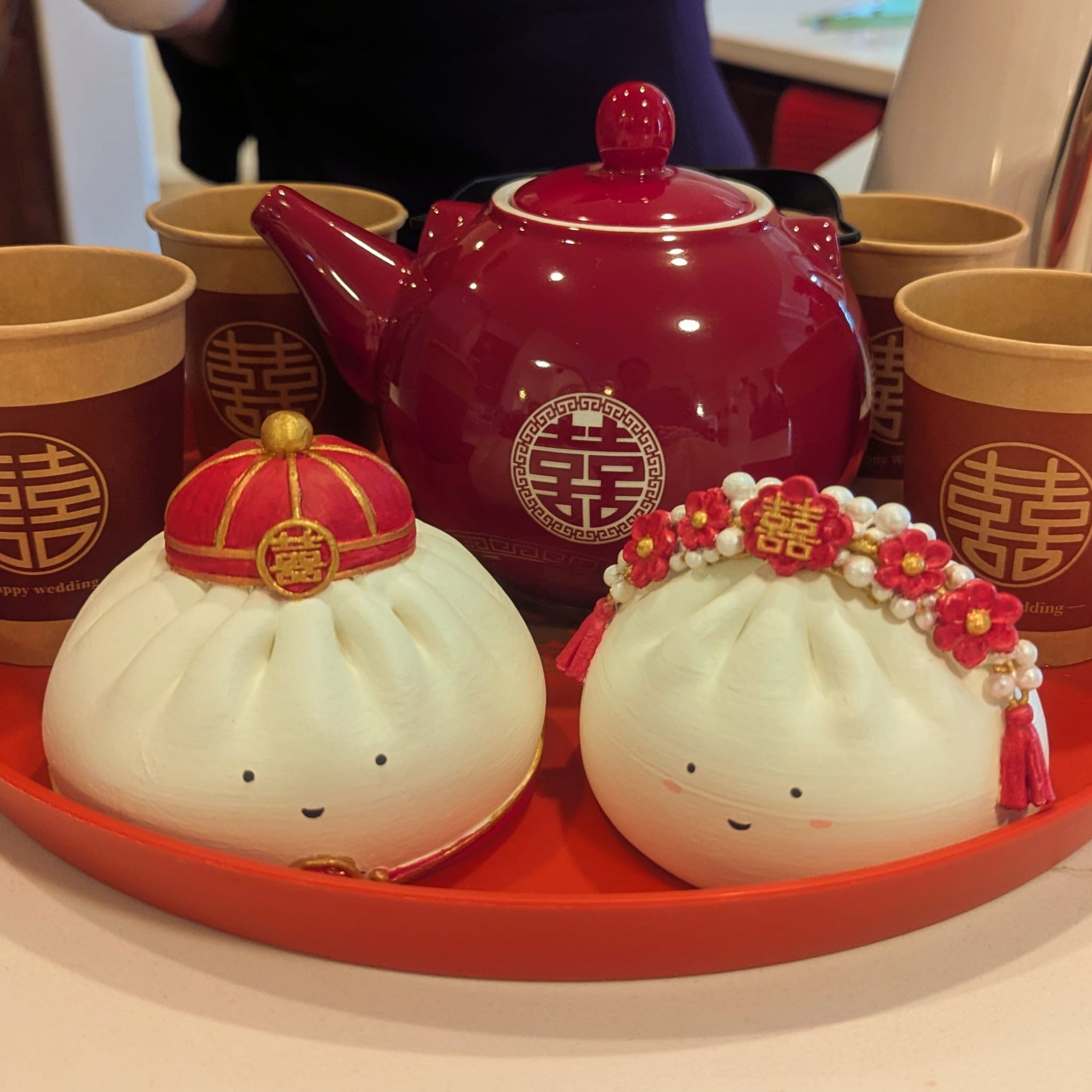 Custom bao bun cake toppers dressed as a bride and groom for a Chinese wedding tea ceremony